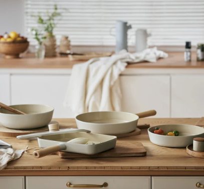 Kitchen benches with pots and pans with decorative items in the background.